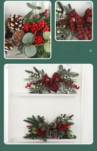 Macro view of Christmas pine branch decor with red berries, pinecones and plaid bows
