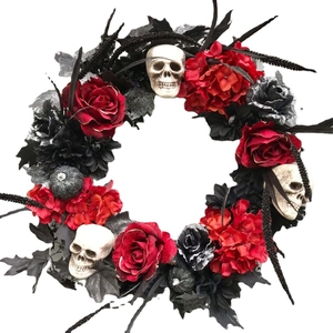 Halloween wreath with red roses, black flowers, and miniature skulls for spooky decor