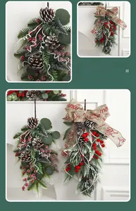Detail of Christmas wall hanging featuring pine cones, red berries and snow-dusted cedar
