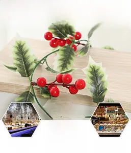 Close-up of artificial red holly berries and green leaves for festive holiday decor