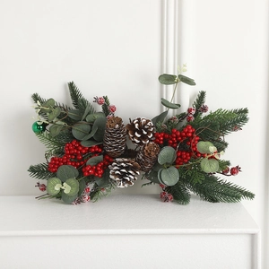Christmas centerpiece with pine needles, red berries, and snow accents on white background