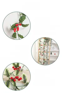 Close-up of festive Christmas vine featuring red berries and green holly leaves on white wall