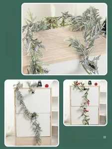 Detailed view of handmade PE pine needles with snow effect and red berry Christmas garland