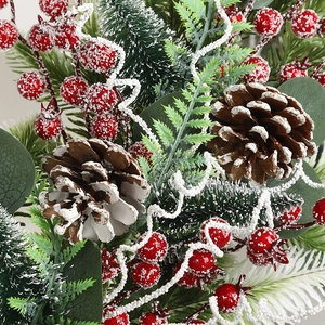 Christmas upside down tree decoration with red berries, pine cones and snow finish
