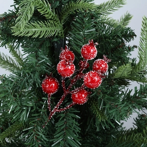 Close-up of frosted red berries branches on green pine needles for Christmas decor