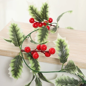 Artificial Christmas red holly berry garland with green leaves for festive home wall decor