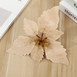 Champagne gold velvet poinsettia flower for Christmas decoration on wooden background
