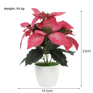 Macro view of artificial red Poinsettia in white pot with dimensions 23cm height and 19.5cm width