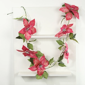 Artificial Christmas poinsettia garland with red flowers and green leaves for decor