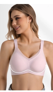 Detail of seamless pink V-neck bra with breathable mesh trim and wide pressure-relief straps