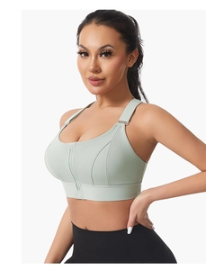Detail view of mint green high-impact sports bra with front zipper and wide straps