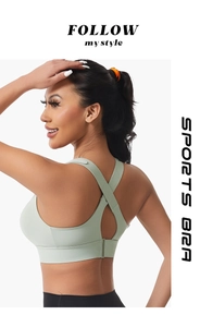 Detail of mint green sports bra featuring a cross back design and adjustable back closure