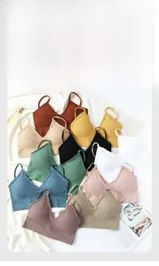 Flat lay of seamless ribbed sports bras in multiple colors with V-neck and thin straps