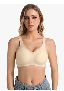 Detail of seamless beige V-neck bra with breathable mesh trim and wide shoulder straps