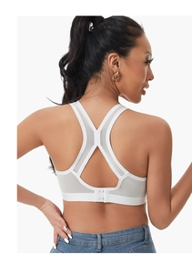 Detailed back view of a white sports bra with breathable mesh and cross-back hook closure
