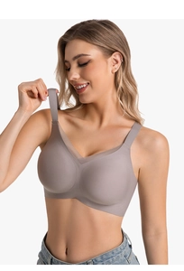 Seamless V-neck bra with sheer mesh trim and wide straps shown on a model with jeans