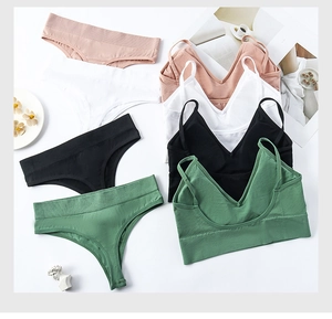 Flat lay of ribbed seamless lingerie sets in pink, white, black, and green colors