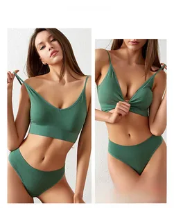 Detail of dark green seamless ribbed sports bra with V-neckline and matching panties