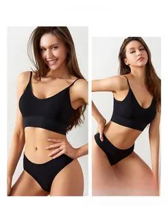 Detail of seamless black sports bra and briefs set with ribbed texture and thin straps