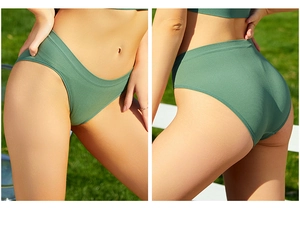Detailed view of dark green ribbed seamless cotton underwear for women in outdoor light