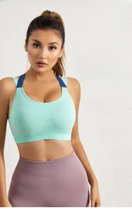 Close-up of seamless mint green sports bra featuring vertical ribbed texture and wide straps