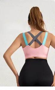 Detail of pink sports bra featuring contrasting blue and grey crossover back straps