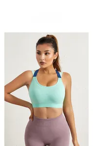 Detail of mint green seamless sports bra with breathable mesh texture and blue straps