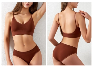 Detail of ribbed brick red seamless bra and briefs set showing the fabric texture and V-neck line