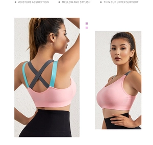 Detailed back view of pink sports bra showing contrast straps and crisscross design