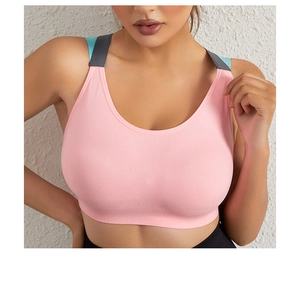 Pink sports bra detail with ribbed fabric and contrasting straps for athletic support