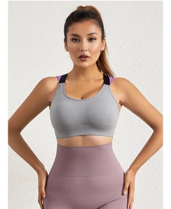 Detail of high-stretch sports bra with color-contrast straps and ribbed waist leggings