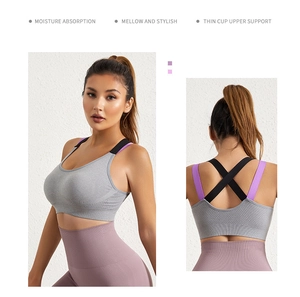 Detail of grey sports bra with criss-cross back straps and purple high-waist yoga leggings