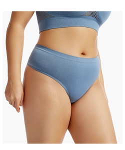 Detail of seamless blue thong with wide elastic waistband on model for sports comfort