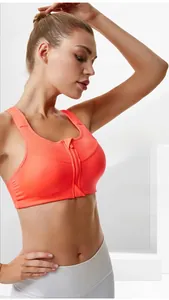 Front zipper closure detail on high impact sports bra in vibrant orange red mesh fabric