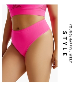 Detail of neon pink seamless thong showing high waist fit and athletic fabric texture