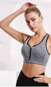 Detailed macro view of gray sports bra featuring high-support front zipper with auto-lock