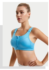 Detail view of front zipper closure and breathable mesh fabric on light blue sports bra