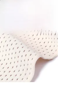 Detail of beige breathable waist trainer fabric showing rectangular mesh ventilation holes