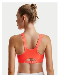 Detail of breathable mesh fabric and adjustable Y-back closure on orange sports bra