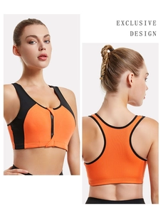 Detail view of seamless racerback sports bra with front zipper in orange and black