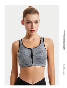 Close-up of gray moisture-wicking sports bra featuring a front zipper and wide support band