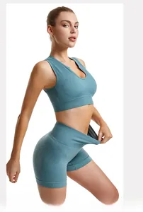 Detailed view of high-elasticity ribbed teal yoga set featuring sports bra and high-waist shorts