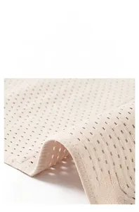 Detail showing the breathable mesh fabric and high-elastic edges of the beige waist trainer