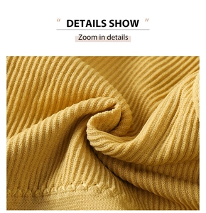 Close-up of yellow ribbed knit fabric texture showing vertical stripes and elastic material