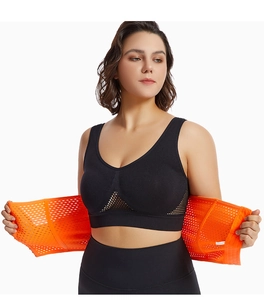 Detail of high-elasticity orange mesh waist trainer with velcro and seamless sports bra