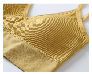 Close-up of ginger yellow seamless ribbed bra with detailed vertical texture and thin strap