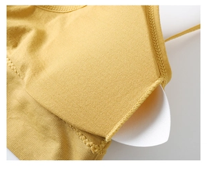 Detail of breathable honeycomb mesh fabric and removable pad of mustard yellow bra