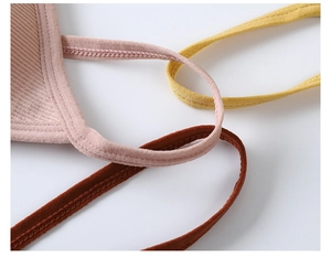 Detailed close-up of ribbed knit bra straps in pink, yellow, and brown with reinforced stitching