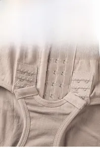 Detailed close-up of the adjustable crotch hook-and-eye closure on beige shapewear