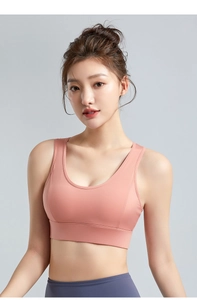 Close-up of peach sports bra with double straps and supportive wide underband